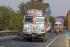 Under-powered Indian trucks driving slowly in the fast lane