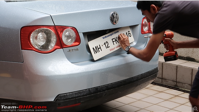 Our first tryst with Volkswagen | Ownership Review of our MK5 VW Jetta-removing-old-plates.png