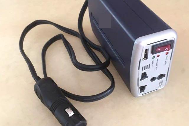 Is it safe to use a DC-to-AC inverter in an EV to charge laptops
